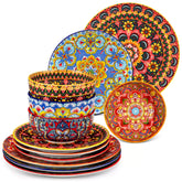 Lumi 12-piece Bohemian dinnerware set for 4 with colorful patterned plates and bowls on a wooden Boho dining table with food