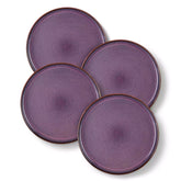 Sata purple stoneware dinner plate set of 4 styled with lamb chops and vegetables on a dinner table farmhouse lipped edge reactive glaze one of a kind finish