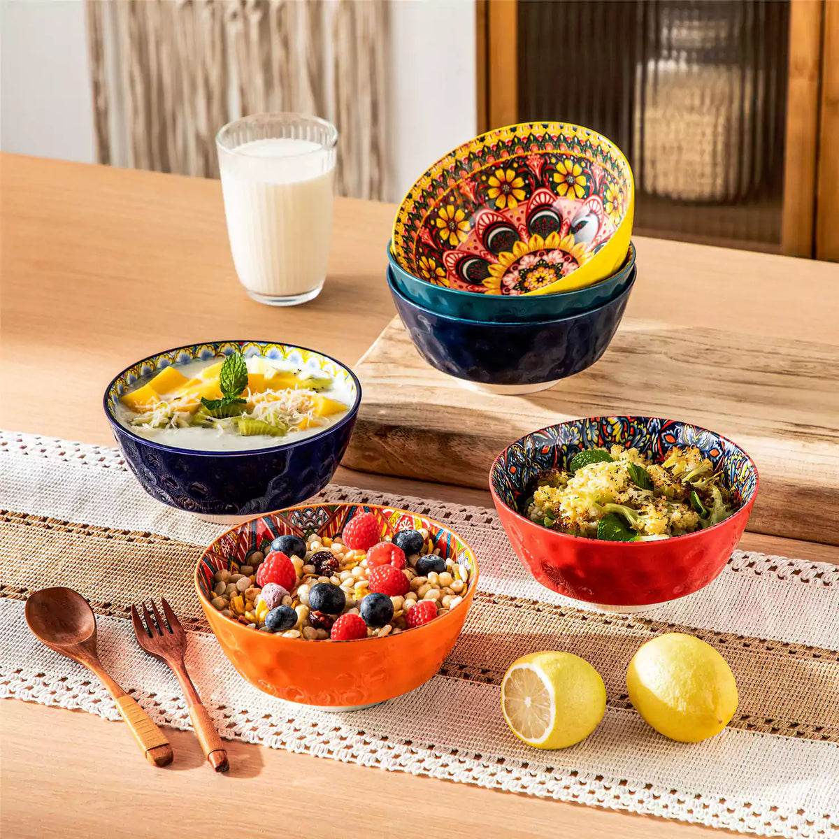 Lumi porcelain 6 piece boho bowl set filled with berries oatmeal and salad on a wood table with lace runner.