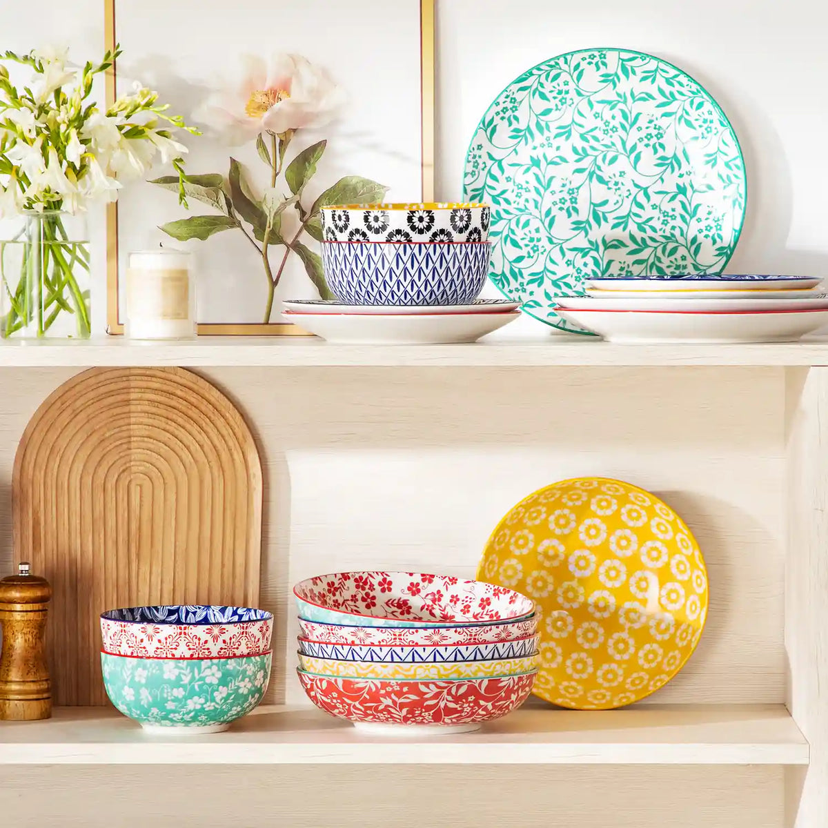 Selene vibrant porcelain pasta bowls set of 6 colorful ceramic dinnerware stacked in white wooden cabinet with fresh flowers and candles.
