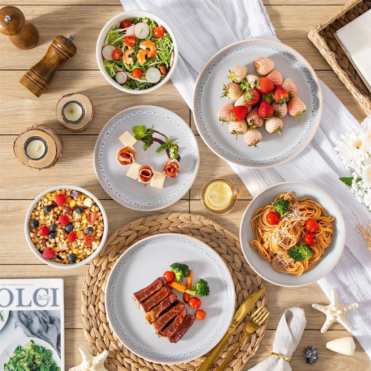 Snow 24-piece white dinnerware set on a rustic table, serving seared steak, berry granola, salad, and strawberries.