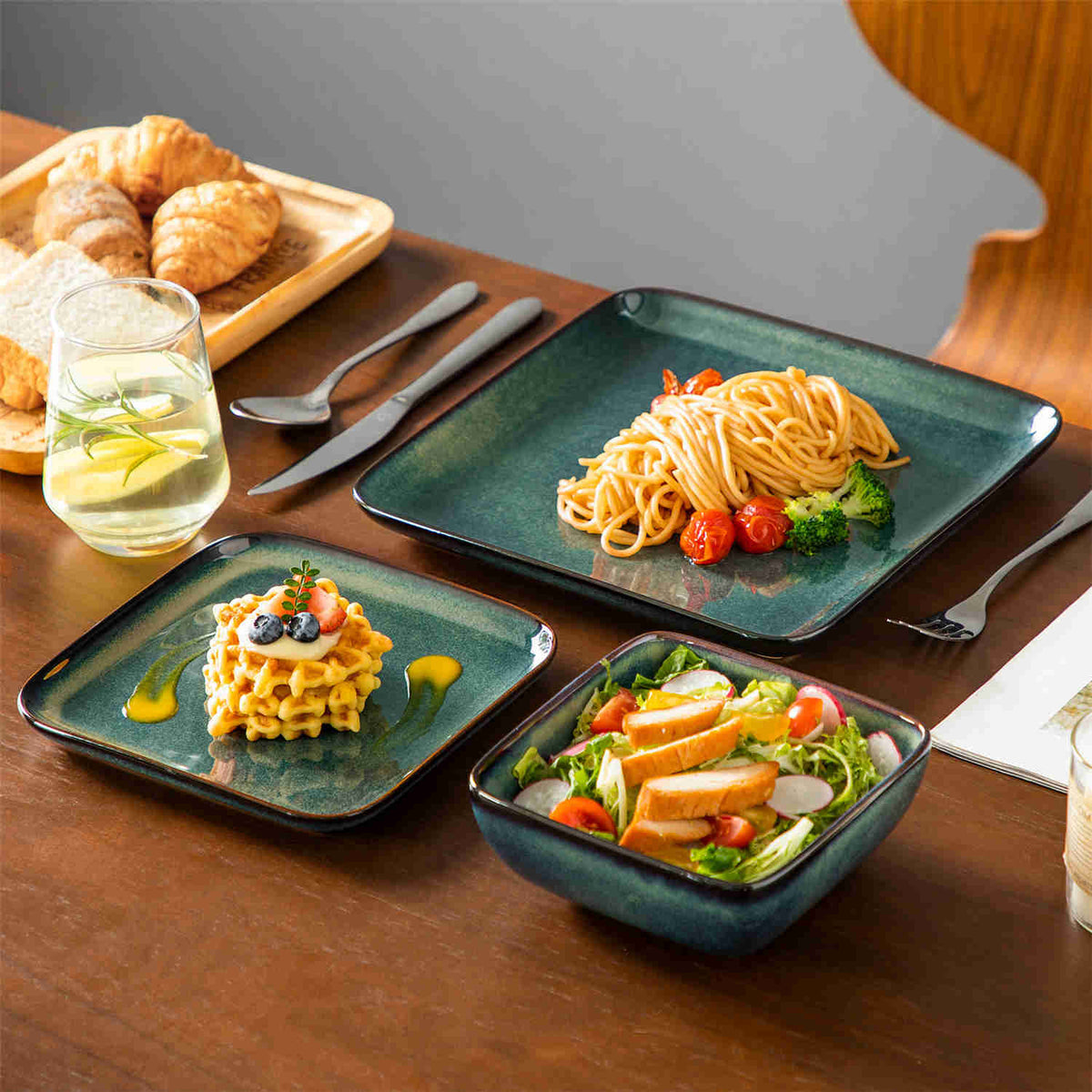 Stern 12-piece dinnerware set with pasta, desserts, fruit salad, and lemonade on wooden table – green gradient square plates