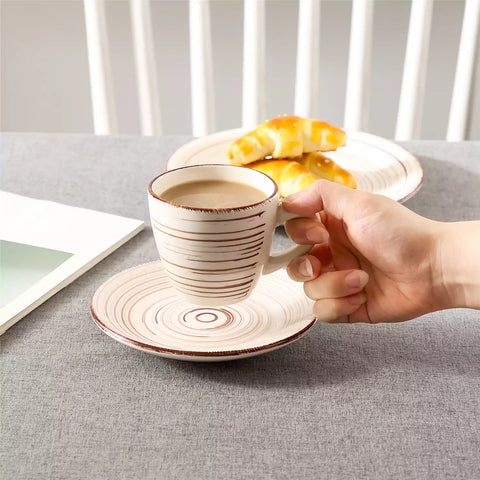 Steaming coffee served in colorful spiral stoneware cups and saucers-handmade vintage design - A
