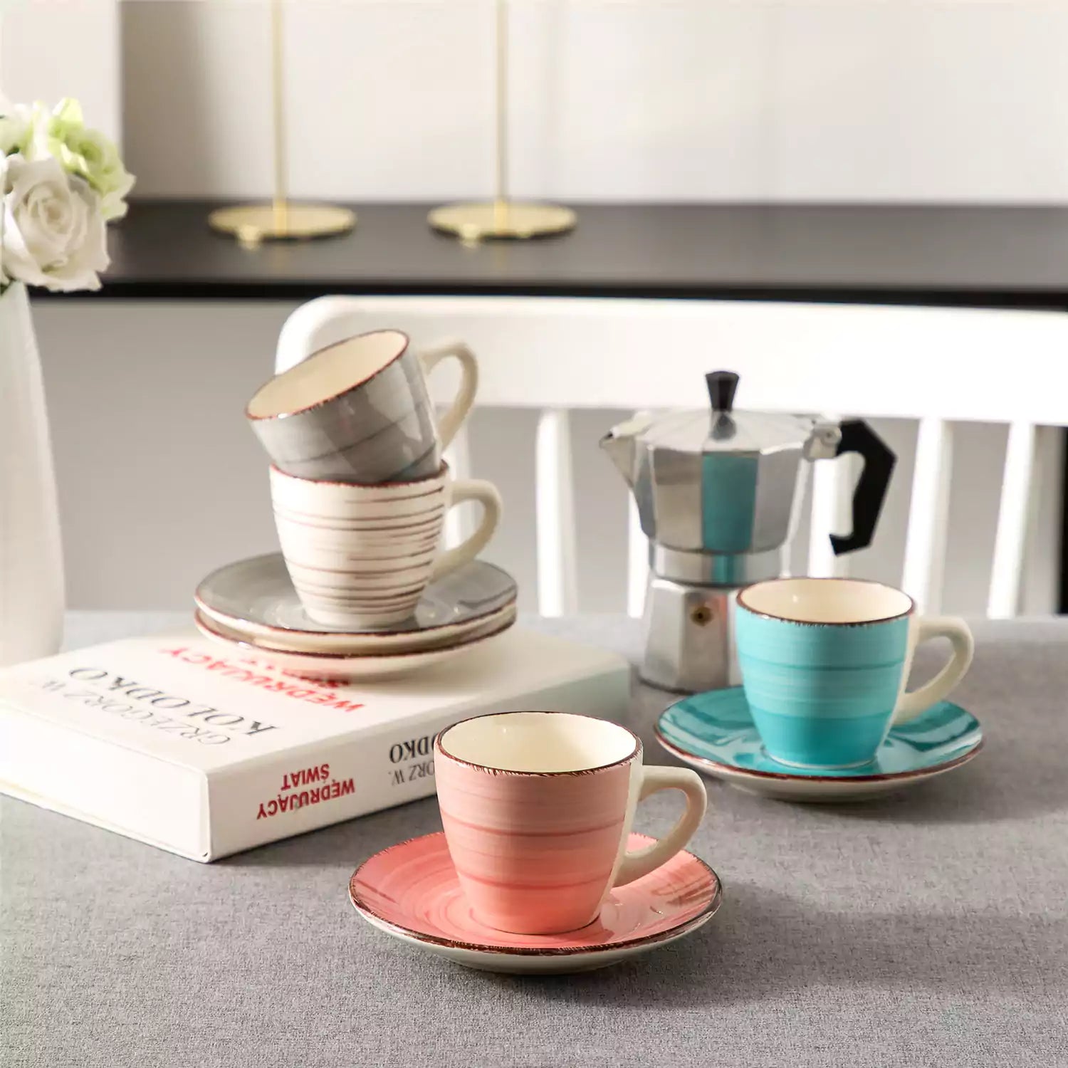 Steaming coffee served in colorful spiral stoneware cups and saucers-handmade vintage design - A