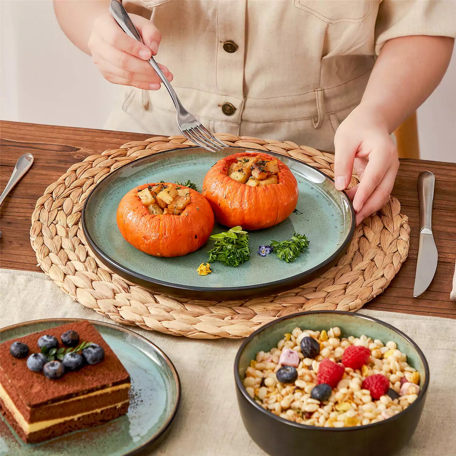 Rustic dining table with Amber 12-piece stoneware dinnerware in farmhouse green - featuring reactive glaze plates - bowls - and utensils by vancasso