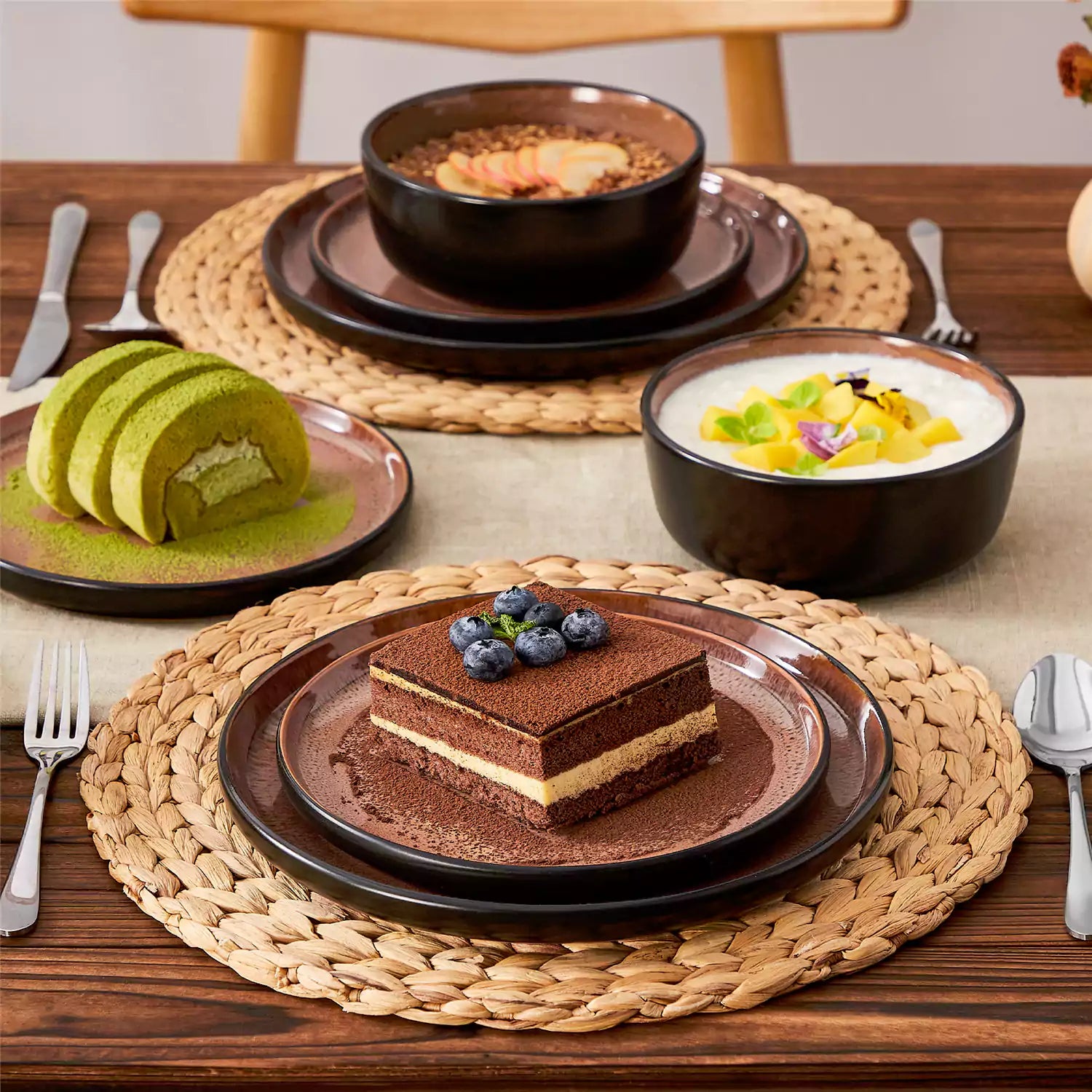Rustic dining table with Amber 12-piece stoneware dinnerware in farmhouse red - featuring reactive glaze plates - bowls - and utensils by vancasso