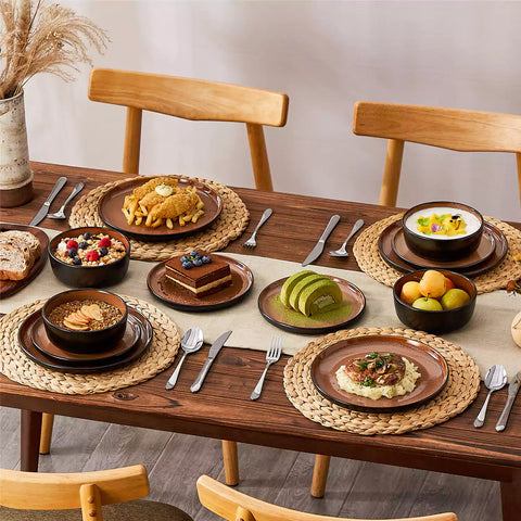Rustic dining table with Amber 12-piece stoneware dinnerware in farmhouse red - featuring reactive glaze plates - bowls - and utensils by vancasso