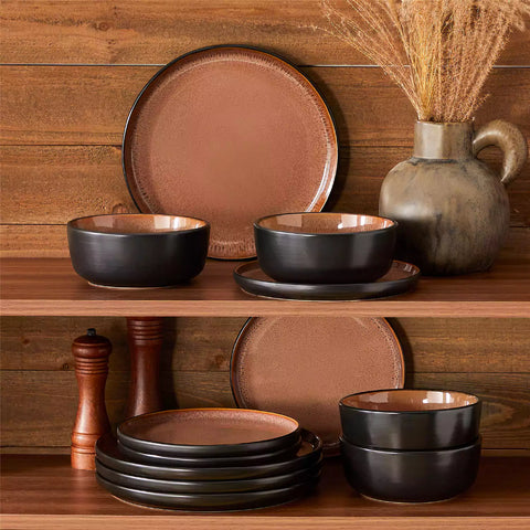 Rustic dining table with Amber 12-piece stoneware dinnerware in farmhouse red - featuring reactive glaze plates - bowls - and utensils by vancasso