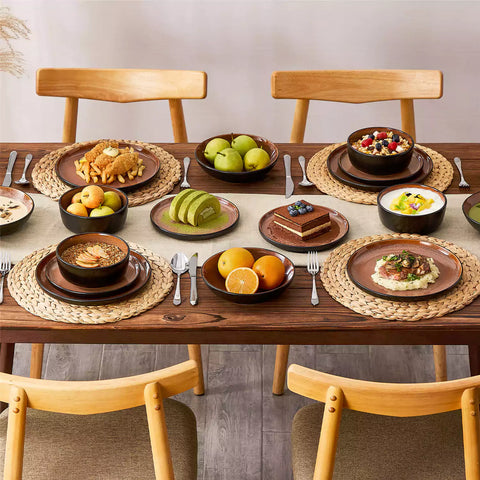 Assorted dishes with soup - dessert - and fruit salad on rustic wooden table - Amber 16-Piece red stoneware dinnerware set with plates and bowls by vancasso