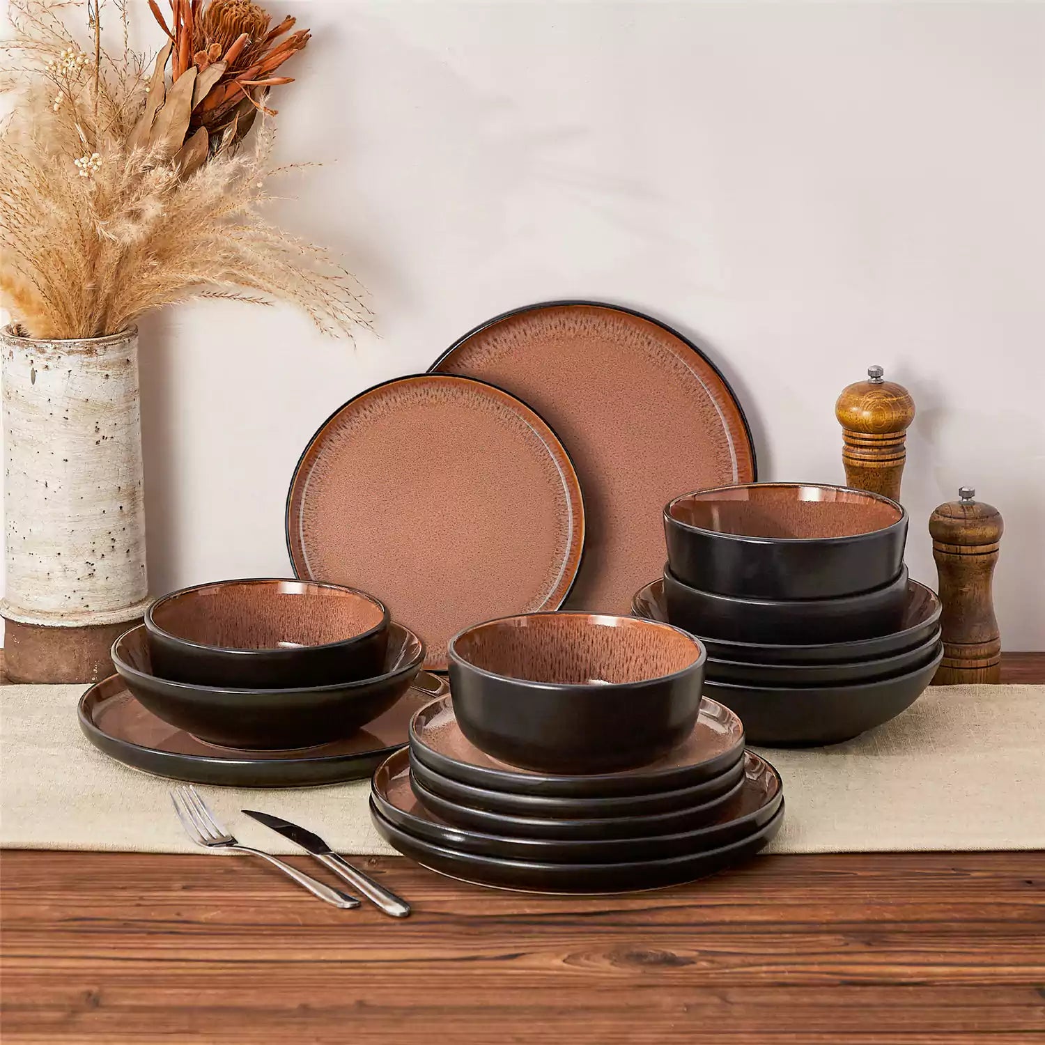 Assorted dishes with soup - dessert - and fruit salad on rustic wooden table - Amber 16-Piece red stoneware dinnerware set with plates and bowls by vancasso