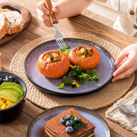 Rustic dining table with Amber 12-piece stoneware dinnerware in farmhouse violet - featuring reactive glaze plates - bowls - and utensils by vancasso