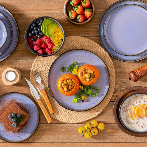 Rustic dining table with Amber 12-piece stoneware dinnerware in farmhouse violet - featuring reactive glaze plates - bowls - and utensils by vancasso