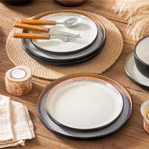 Rustic dining table with Amber 12-piece stoneware dinnerware in farmhouse beige - featuring reactive glaze plates - bowls - and utensils by vancasso