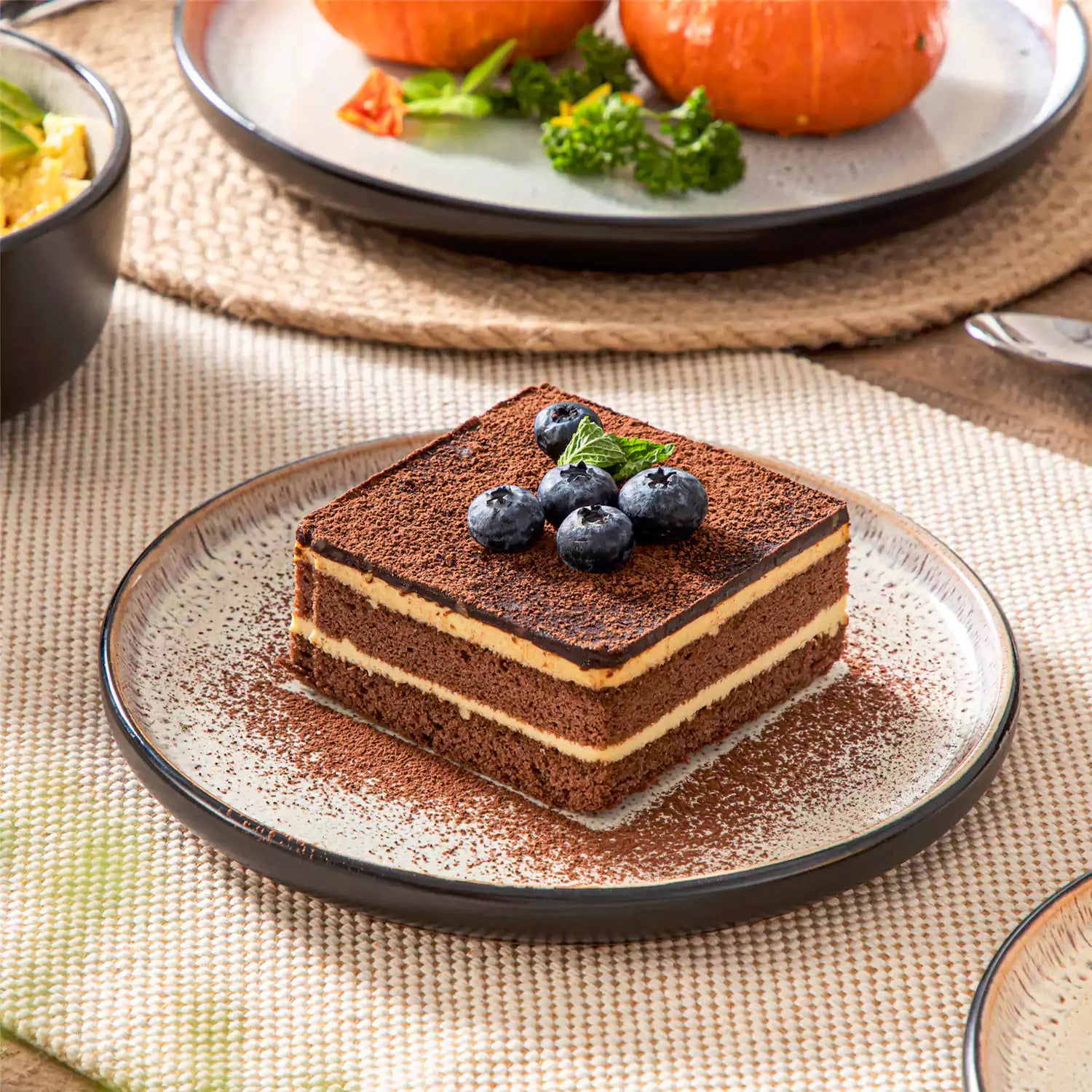 Assorted dishes with soup - dessert - and fruit salad on rustic wooden table - Amber 16-Piece beige stoneware dinnerware set with plates and bowls by vancasso