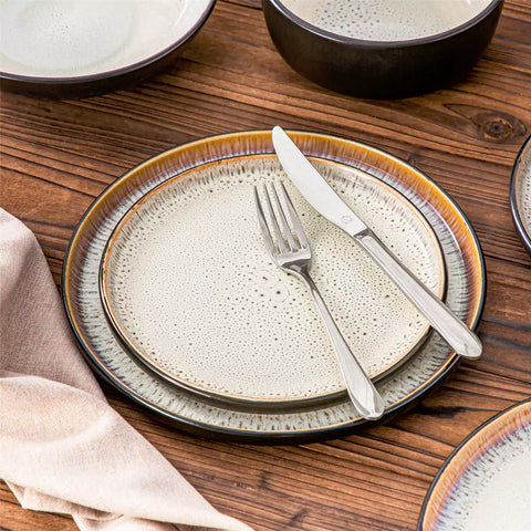 Assorted dishes with soup - dessert - and fruit salad on rustic wooden table - Amber 16-Piece beige stoneware dinnerware set with plates and bowls by vancasso