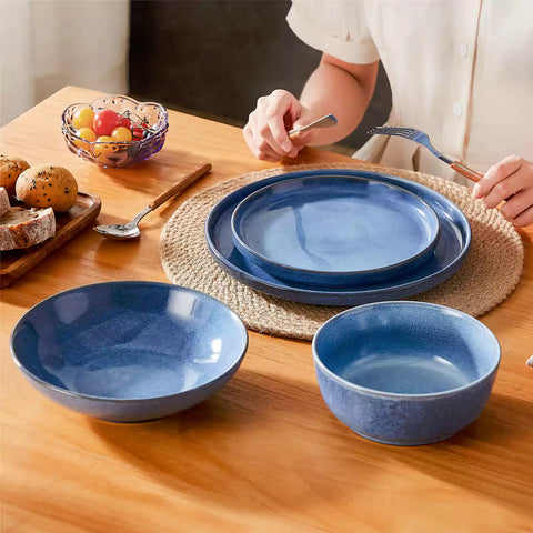 Handcrafted blue stoneware with reactive glaze on woven placemats - perfect for farmhouse tables