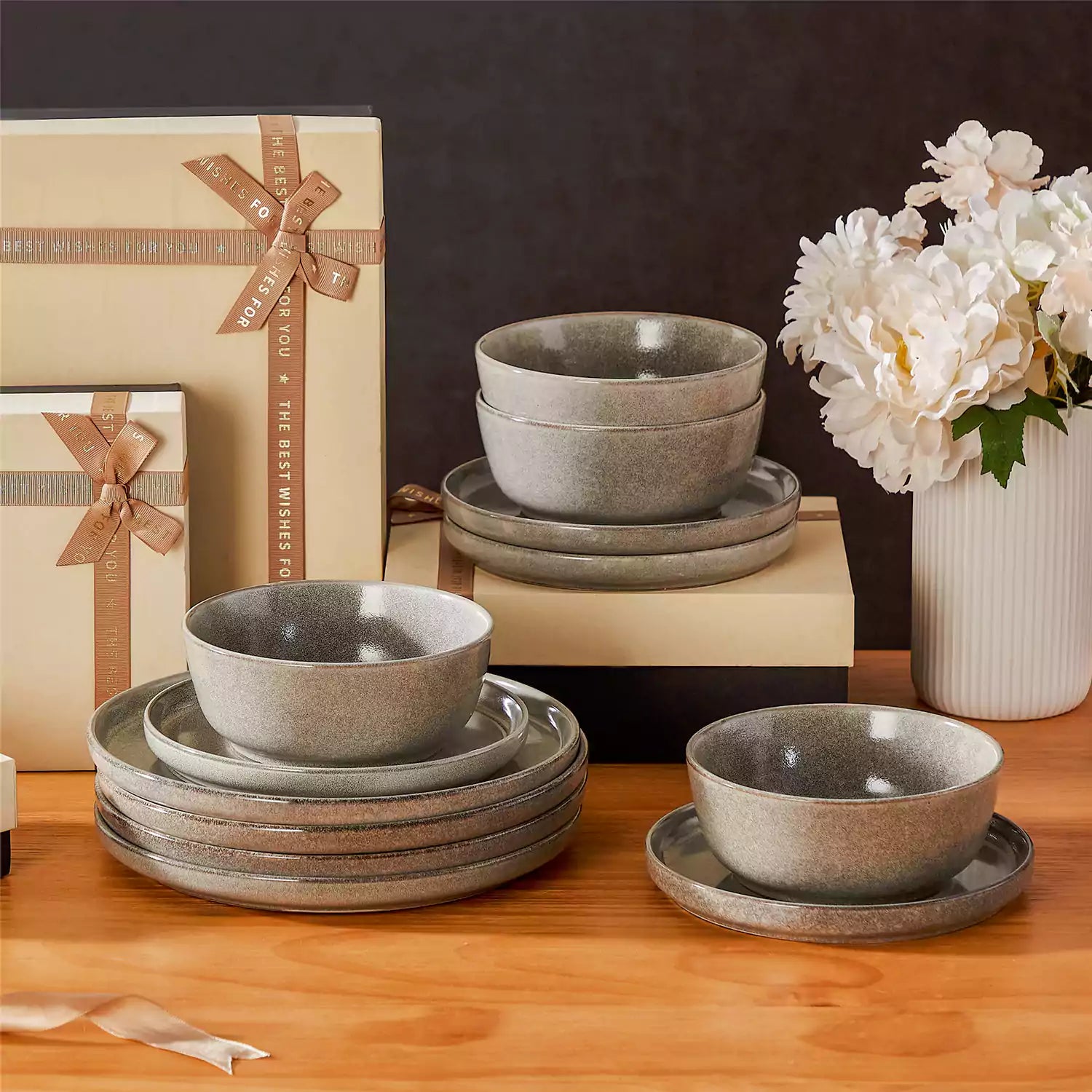 Brown stoneware plates and bowls with reactive glaze on farmhouse wooden table with woven placemats