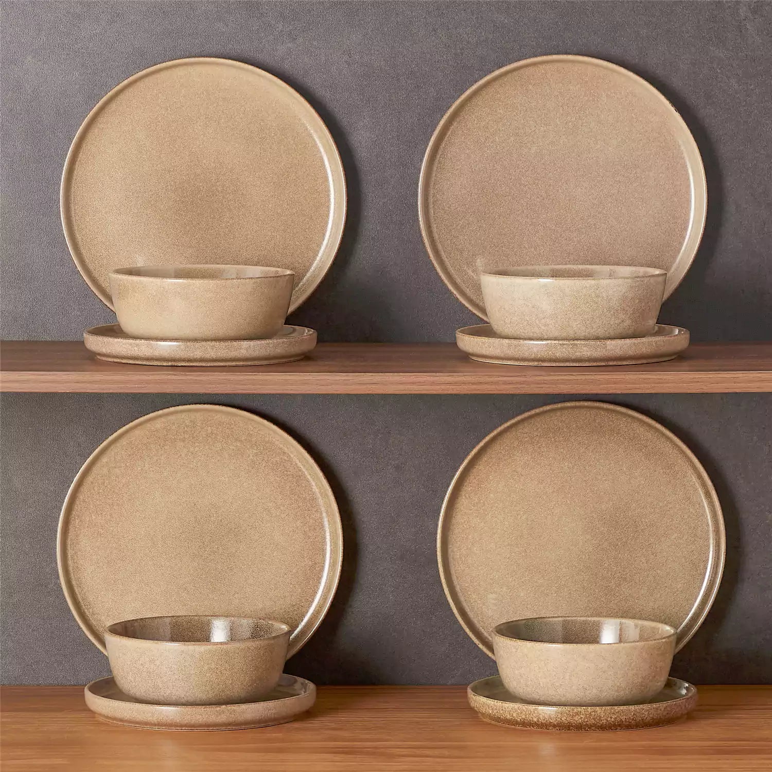 Caramel stoneware plates and bowls with reactive glaze on farmhouse wooden table with woven placemats
