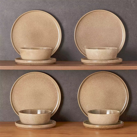 Caramel stoneware plates and bowls with reactive glaze on farmhouse wooden table with woven placemats