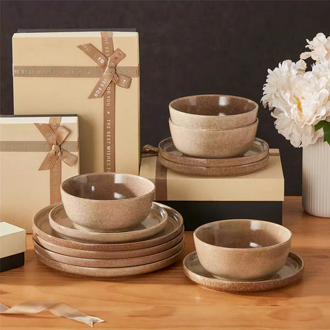 Caramel stoneware plates and bowls with reactive glaze on farmhouse wooden table with woven placemats