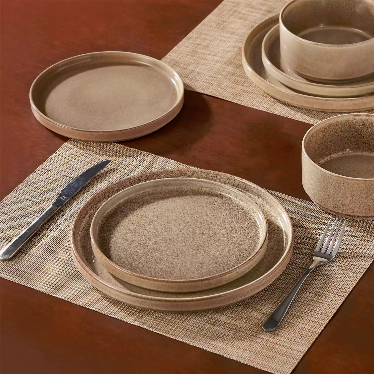 Anya 12 piece straight edge stoneware dinner set in caramel with food on a rustic farmhouse wooden table with a side salad and cutlery