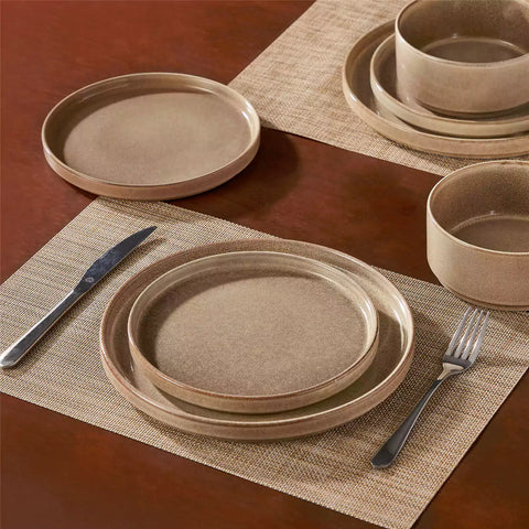 Anya 12 piece straight edge stoneware dinner set in caramel with food on a rustic farmhouse wooden table with a side salad and cutlery