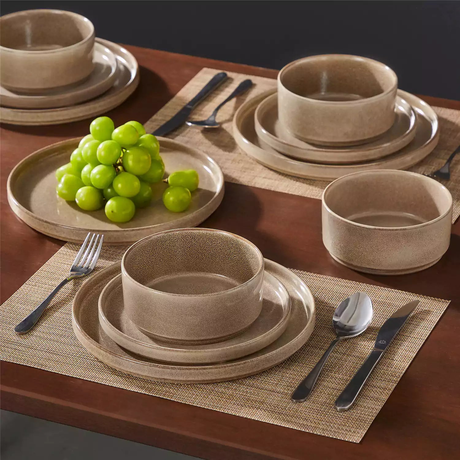 Anya 12 piece straight edge stoneware dinner set in caramel with food on a rustic farmhouse wooden table with a side salad and cutlery