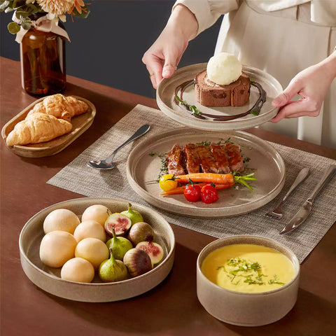 Anya 16 piece straight edge stoneware dinner set in caramel with pasta soup and pastries on a modern farmhouse table