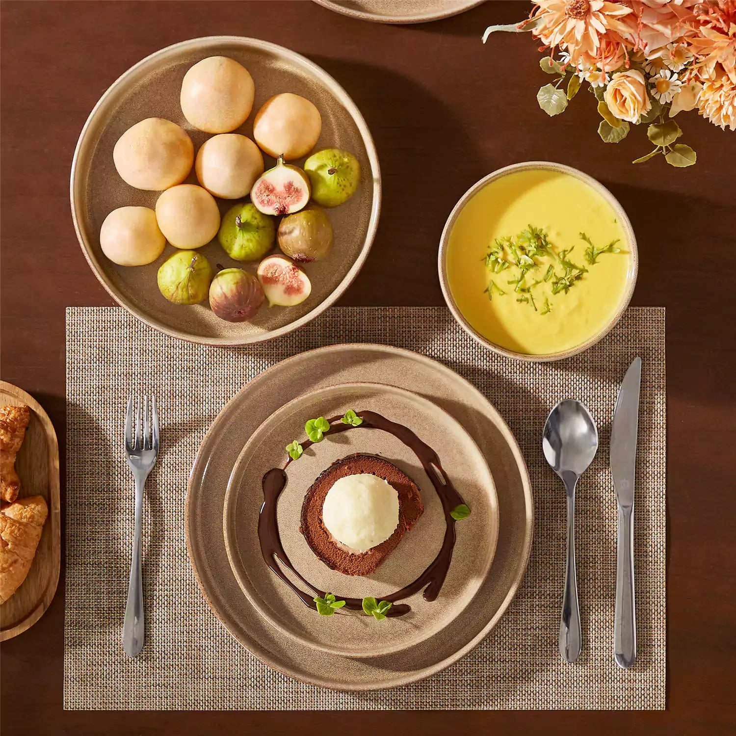 Anya 16 piece straight edge stoneware dinner set in caramel with pasta soup and pastries on a modern farmhouse table