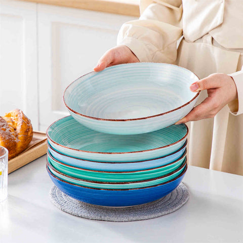Blue Bonita large stoneware bowls set of 6 on a white table - each filled with pasta - pumpkin soup - and fruit salad - creating a bright and inviting table setting