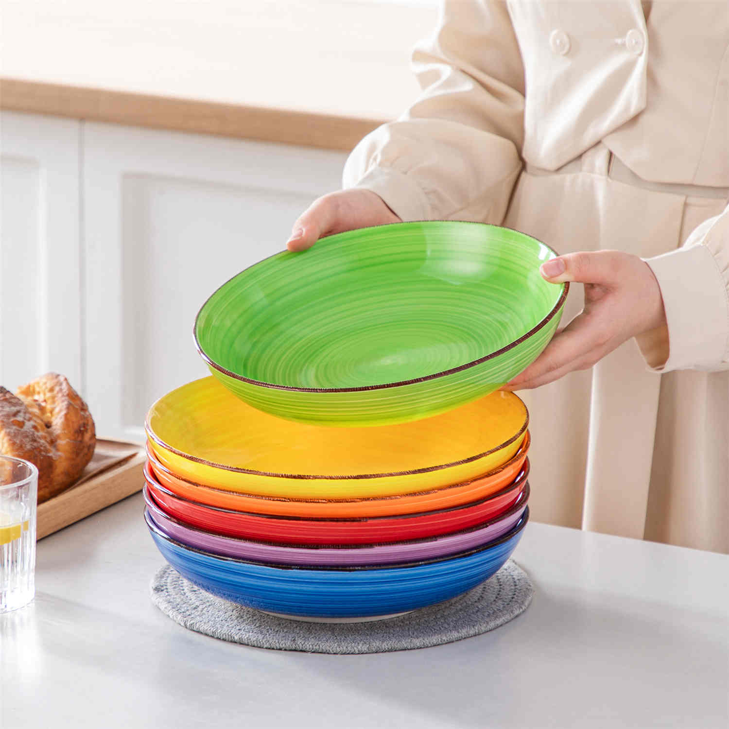 Multicolor Bonita large stoneware bowls set of 6 on a white table - each filled with pasta - pumpkin soup - and fruit salad - creating a bright and inviting table setting