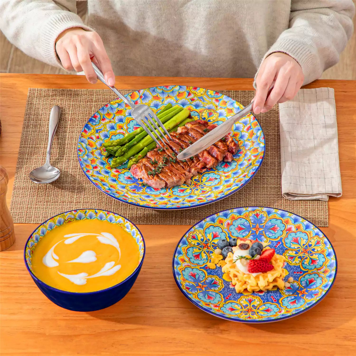 Bohemian Lumi porcelain dinnerware set for 6 with vibrant patterned plates diamond-embossed bowls served with fresh food bread and olive oil on wooden table