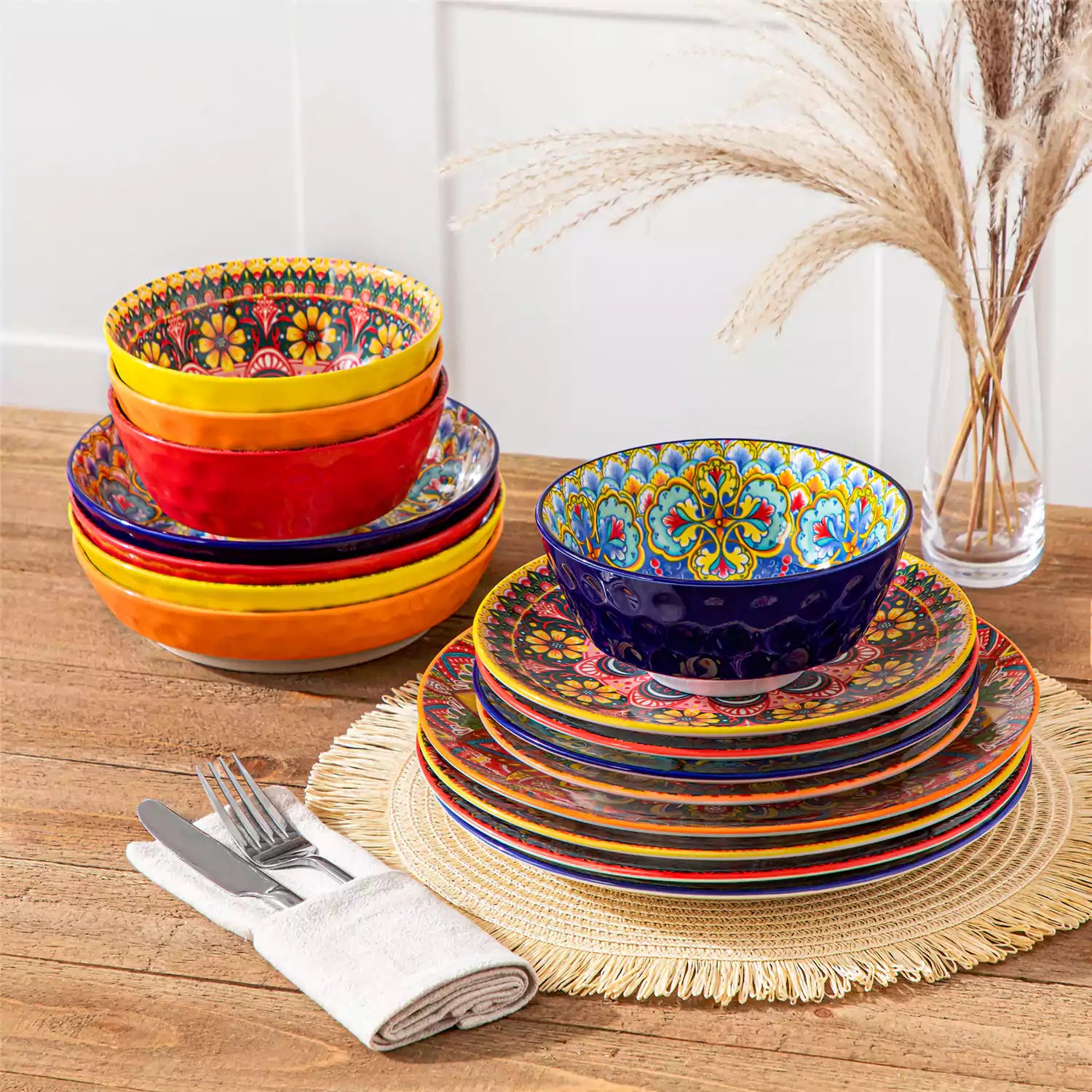 Bohemian Lumi 16 piece porcelain dinnerware set with colorful patterned plates and diamond-embossed bowls on a wooden table with assorted food and cutlery