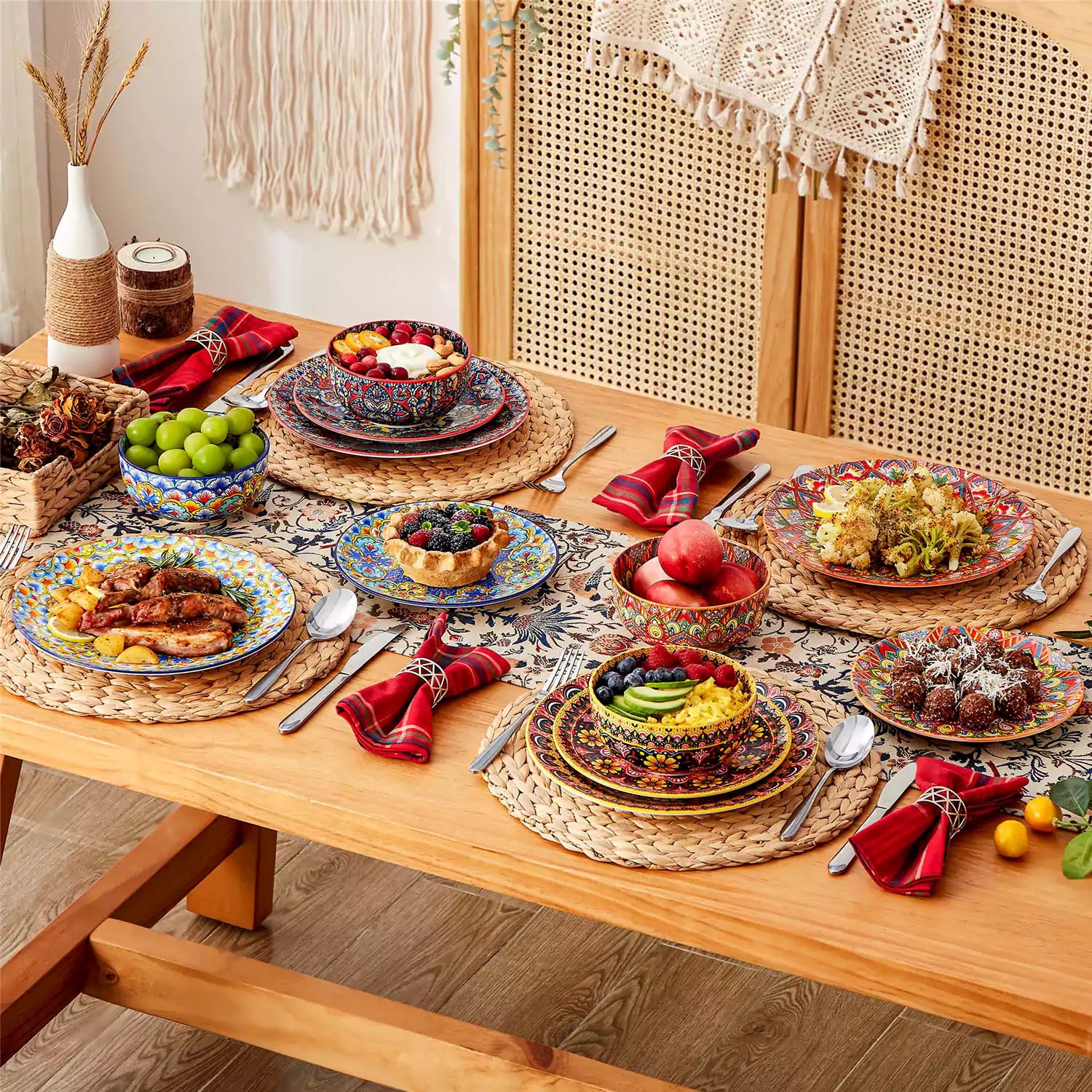Lumi 12-piece Bohemian dinnerware set for 4 with colorful patterned plates and bowls on a wooden Boho dining table with food