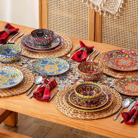 Lumi 12-piece Bohemian dinnerware set for 4 with colorful patterned plates and bowls on a wooden Boho dining table with food