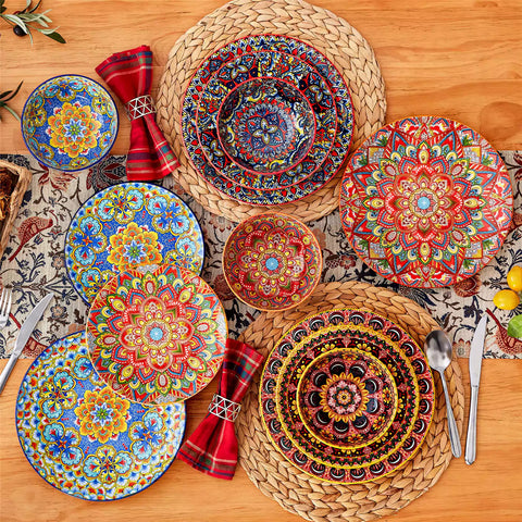 Lumi 12-piece Bohemian dinnerware set for 4 with colorful patterned plates and bowls on a wooden Boho dining table with food