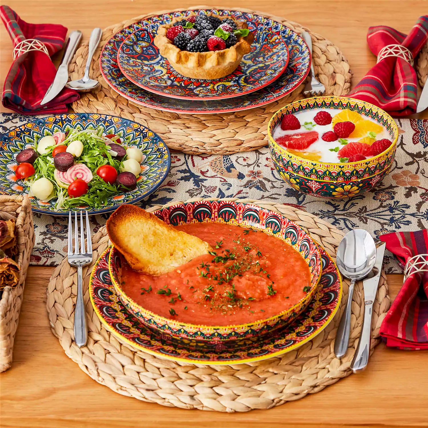 Bohemian style dining table set with Lumi 24 piece colorful dinnerware bowls and vibrant table décor ready for a lively meal