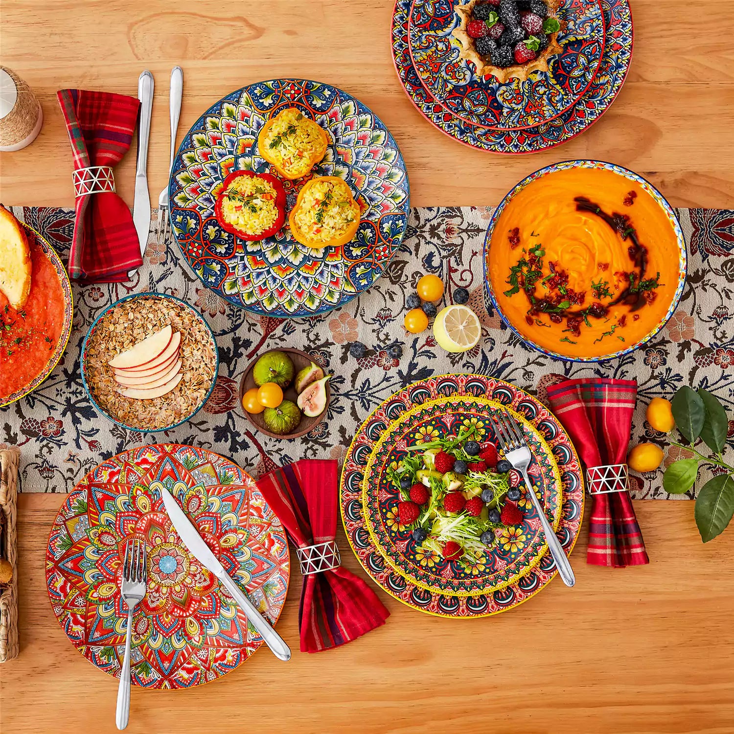 Bohemian style dining table set with Lumi 24 piece colorful dinnerware bowls and vibrant table décor ready for a lively meal
