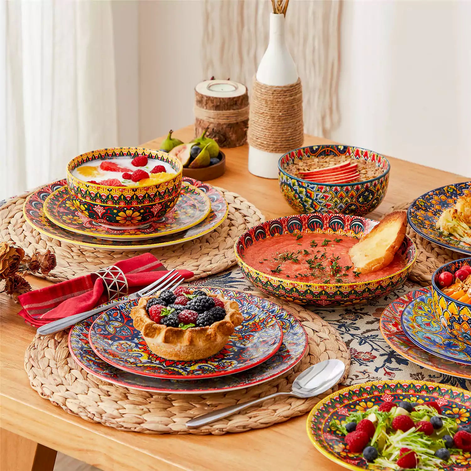 Bohemian style dining table set with Lumi 24 piece colorful dinnerware bowls and vibrant table décor ready for a lively meal