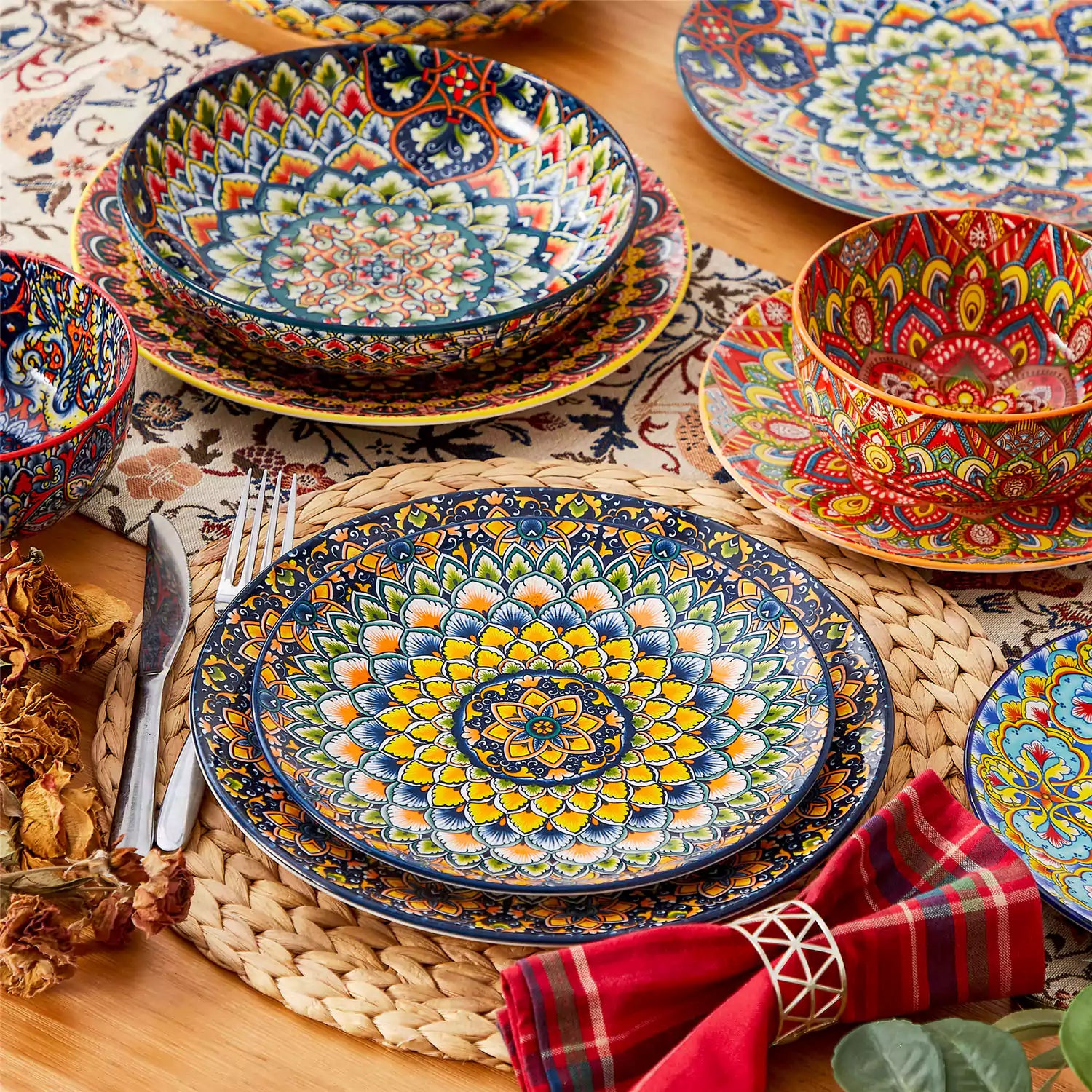 Bohemian style dining table set with Lumi 24 piece colorful dinnerware bowls and vibrant table décor ready for a lively meal
