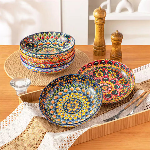 Vibrant Lumi porcelain pasta bowls filled with fruit salad pumpkin soup and pasta on a wooden dining table