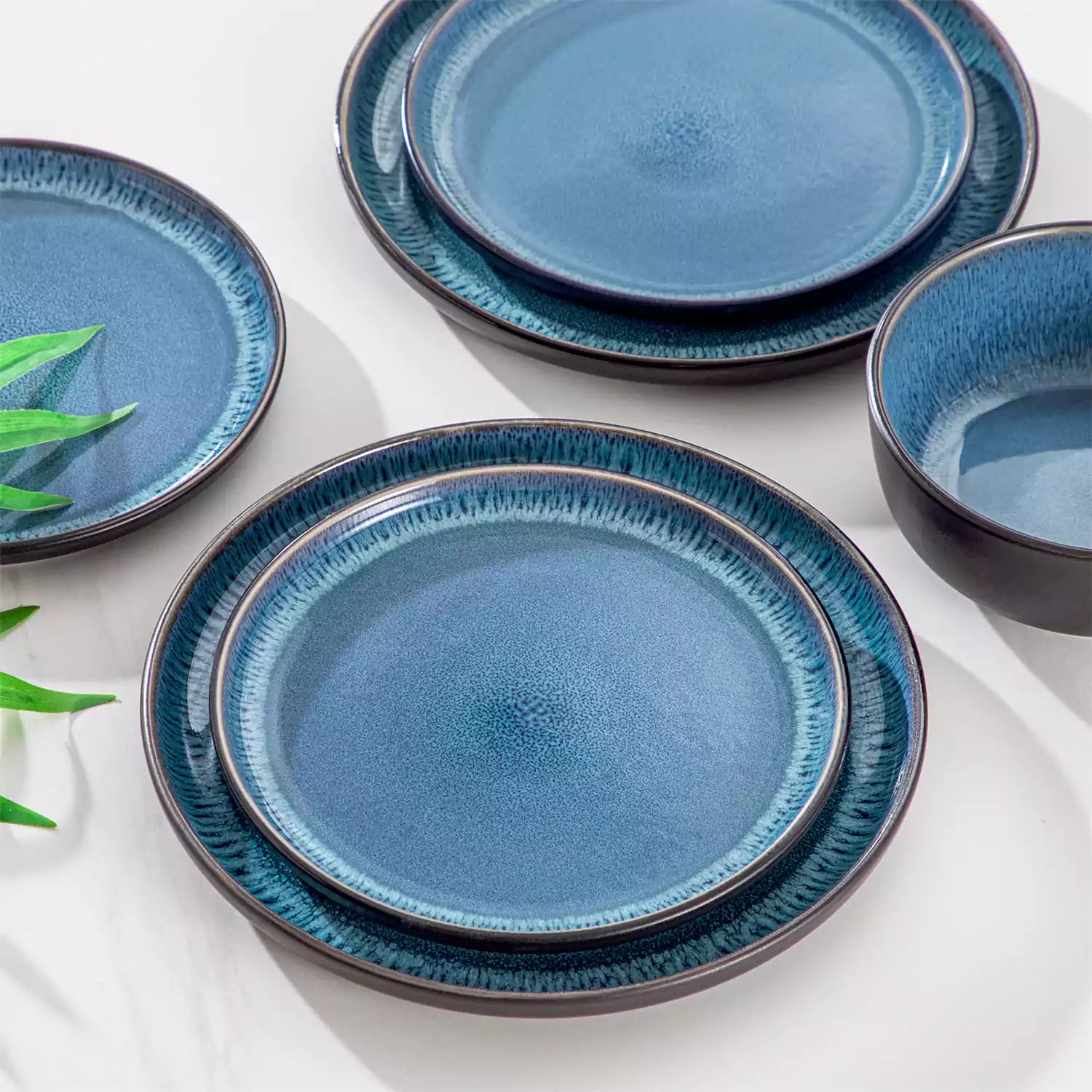 Playa 18-Piece Stoneware Dinnerware Set with plates and bowls for 6 - featuring a unique blue reactive glaze and a farmhouse-inspired style-vancasso