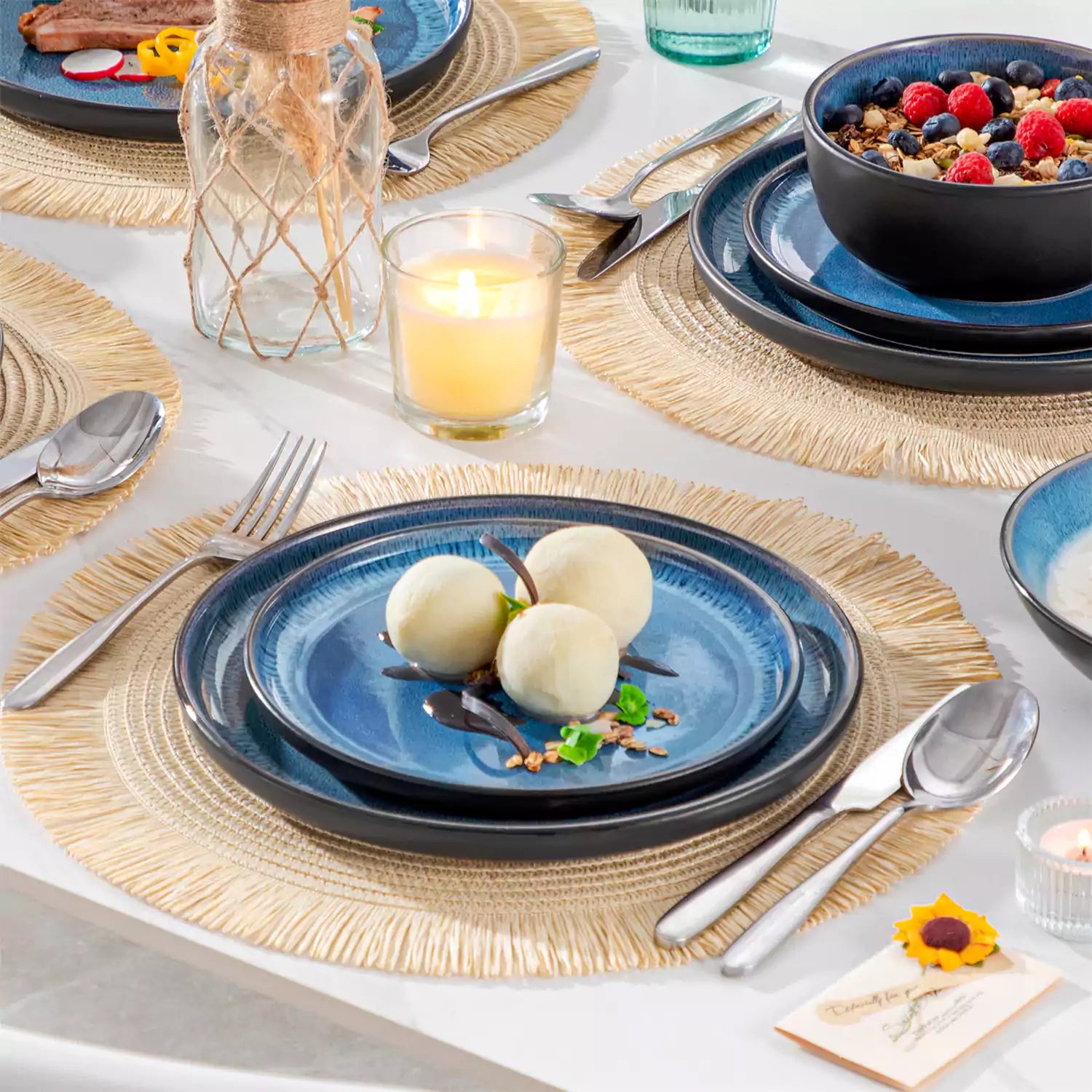 A glossy blue 24-piece stoneware dinnerware set from the Playa collection - featuring farmhouse charm with plates and bowls for 6 people-vancasso