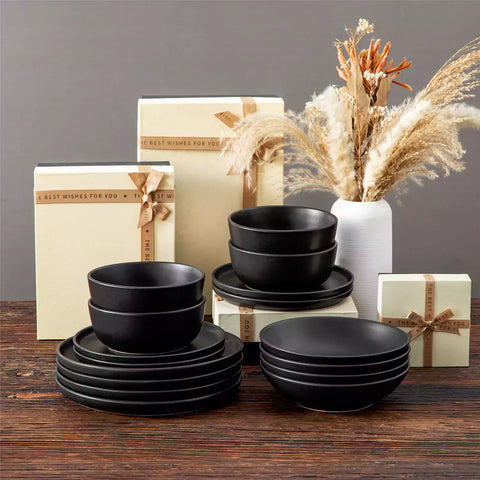 A matte black 16-piece stoneware dinnerware set from the Playa collection - offering a modern touch with plates and bowls for 4 people-vancasso.