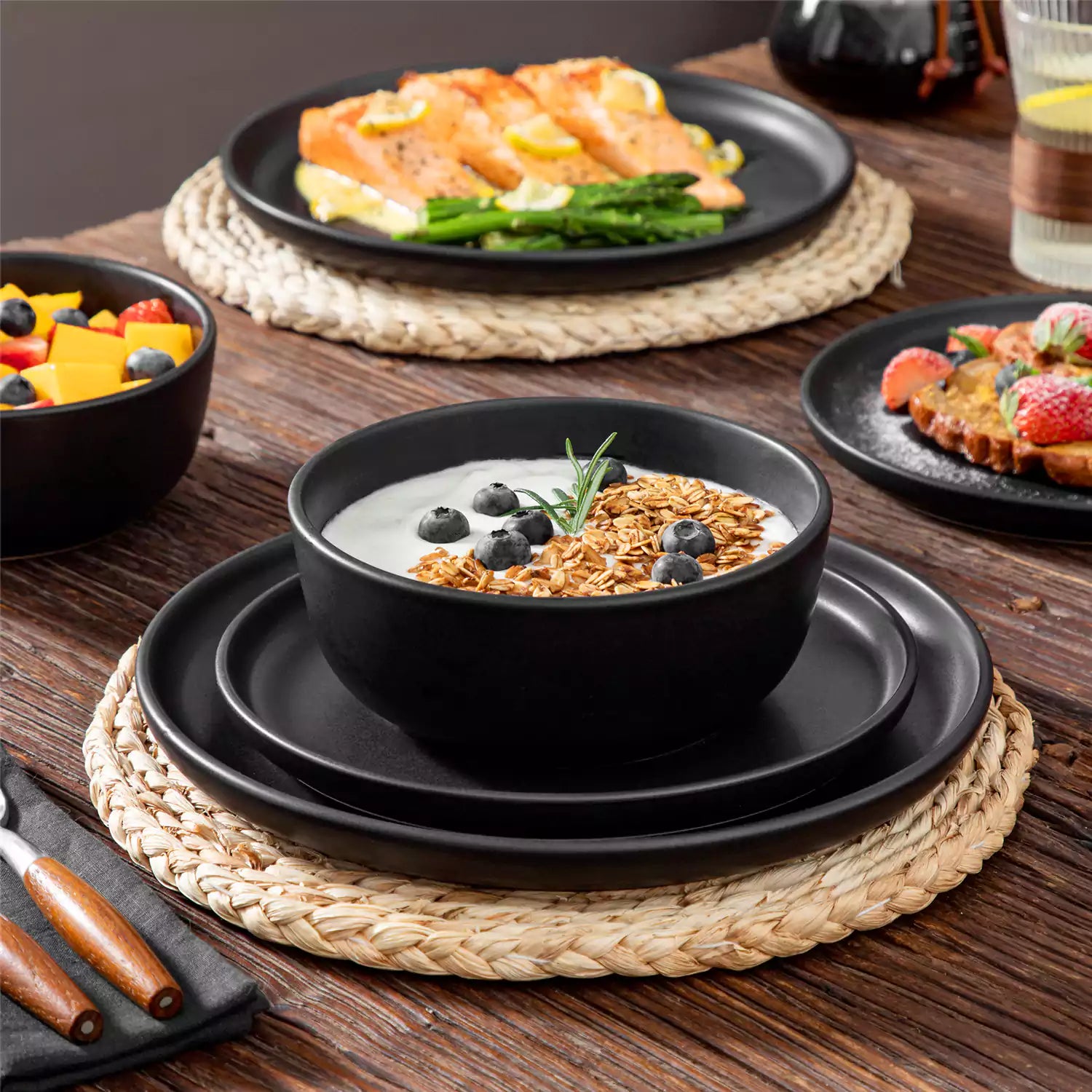 Playa 18-Piece Stoneware Dinnerware Set for 6, featuring plates and bowls in a modern Ibiza-inspired style with a matte black finish-vancasso