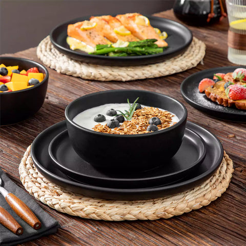Playa 18-Piece Stoneware Dinnerware Set for 6, featuring plates and bowls in a modern Ibiza-inspired style with a matte black finish-vancasso