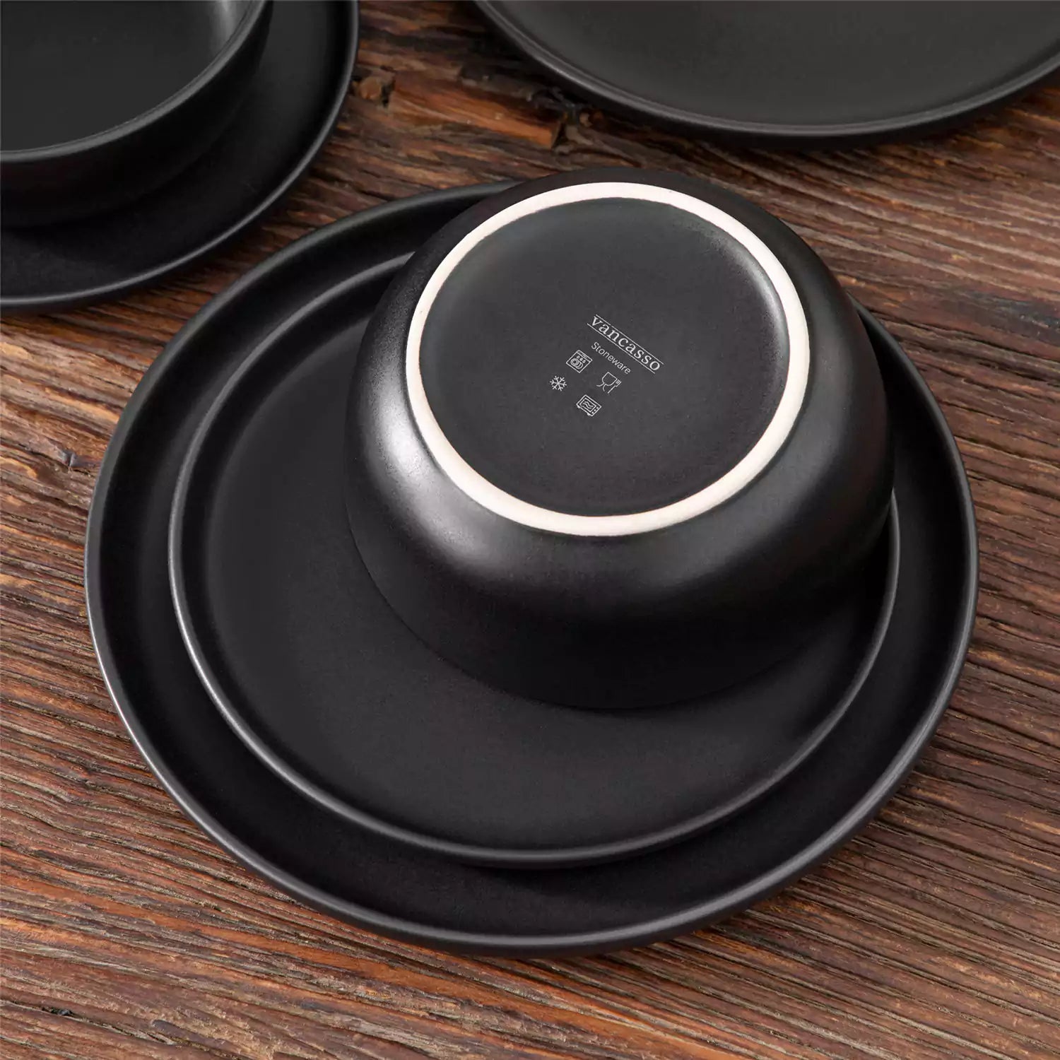 Playa 18-Piece Stoneware Dinnerware Set for 6, featuring plates and bowls in a modern Ibiza-inspired style with a matte black finish-vancasso