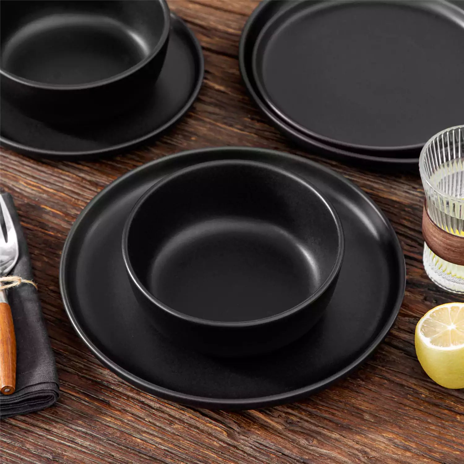 Playa 18-Piece Stoneware Dinnerware Set for 6, featuring plates and bowls in a modern Ibiza-inspired style with a matte black finish-vancasso