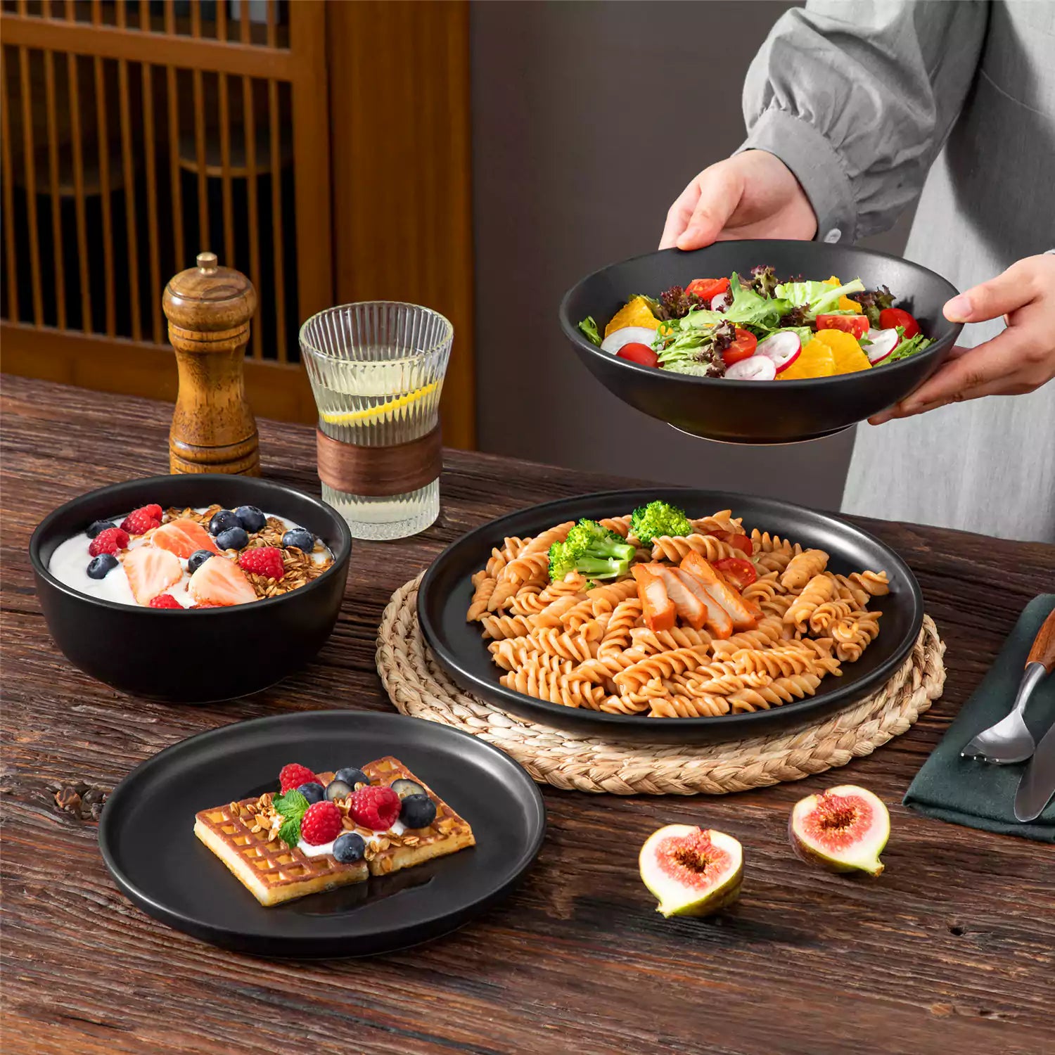 A matte black 24-piece stoneware dinnerware set from the Playa collection by vancasso - adding a modern flair with plates and bowls for 6 people
