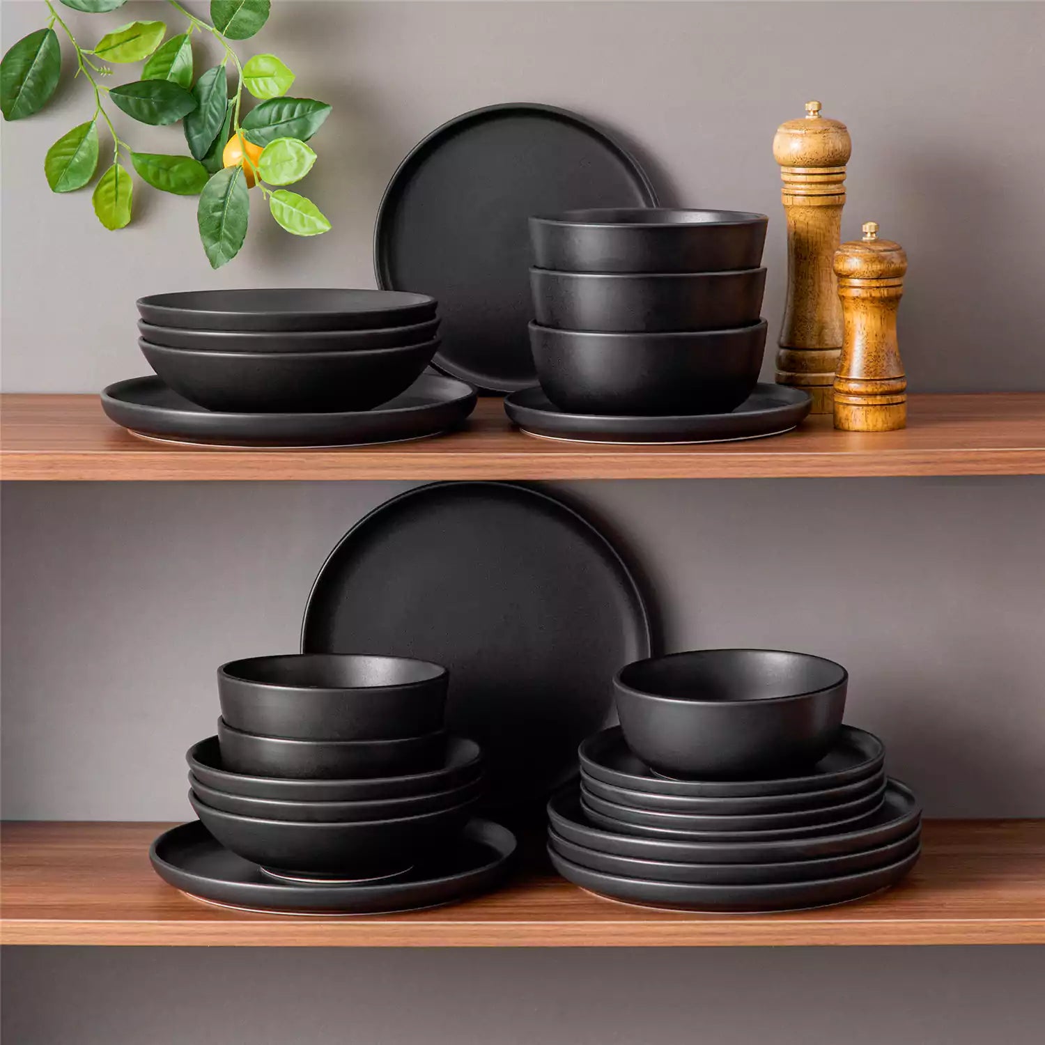 A matte black 24-piece stoneware dinnerware set from the Playa collection by vancasso - adding a modern flair with plates and bowls for 6 people